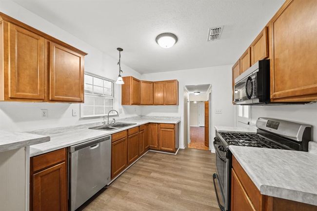 Beautiful kitchen with wood cabinets, lots of space, granite countertops, and fantastic stainless appliances. | Image 9