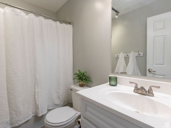 Bathroom with vanity, toilet, and a shower with shower curtain | Image 14