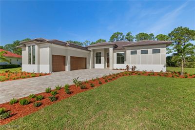 Prairie-style house featuring a front lawn and a garage | Image 2