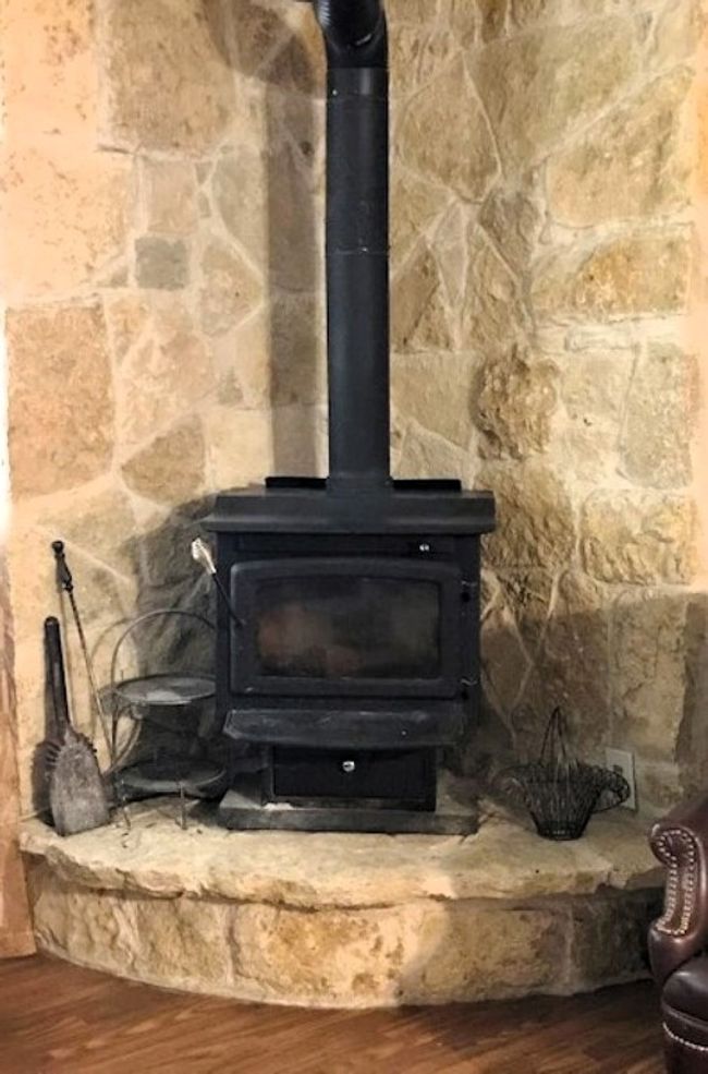 Details with a wood stove and wood finished floors | Image 15