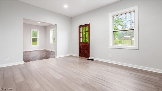 Living room featuring light wood-style floors, plenty of natural light, and recessed lighting | Image 5