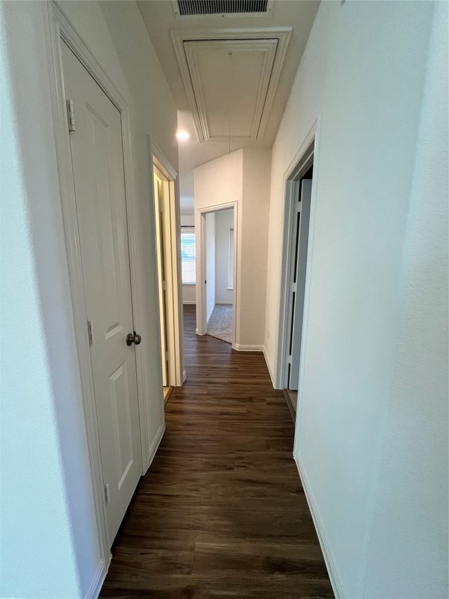 Hall featuring attic access and dark wood-style flooring | Image 20