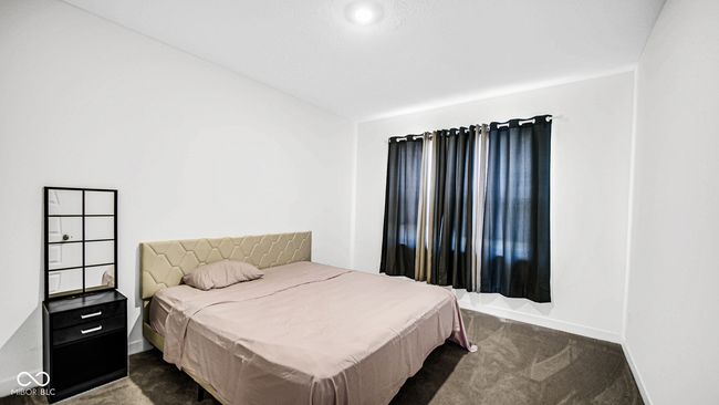 bedroom with dark colored carpet and baseboards | Image 8