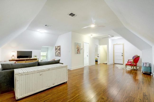 Second story living room featuring lofted ceiling, wood finished floors, and ceiling fan | Image 29