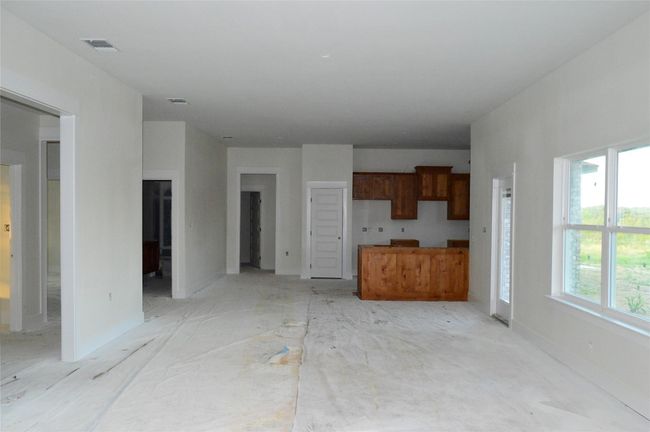 Unfurnished living room featuring baseboards | Image 9