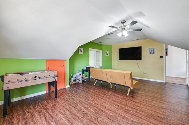 Rec room with lofted ceiling, ceiling fan, and hardwood / wood-style floors | Image 14