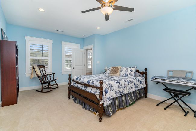 Bedroom featuring recessed lighting, light carpet, a ceiling fan, and baseboards | Image 29