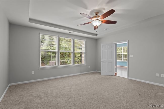 Spare room with a tray ceiling, a ceiling fan, and carpet flooring | Image 17