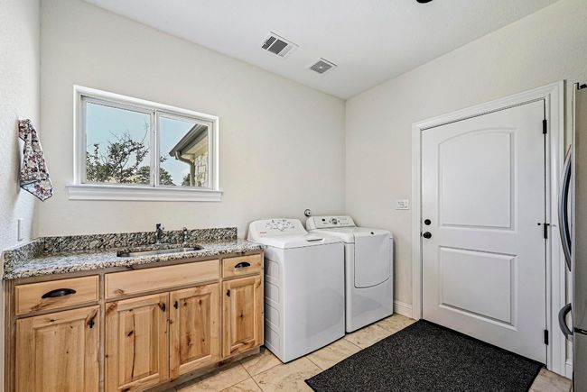Washroom featuring cabinet space and washer and clothes dryer | Image 28