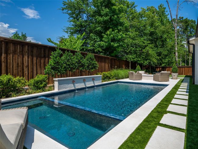 View of swimming pool with an outdoor living space, a fenced backyard, a pool with connected hot tub, and a patio | Image 38