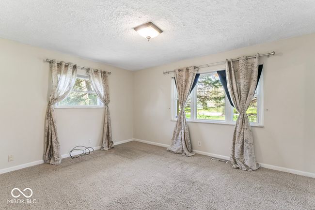 spare room with a wealth of natural light, carpet, and a textured ceiling | Image 21