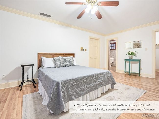 20 x 12' primary bedroom with walk-in closet (7x6) and storage area (13 x 8), en-suite bathroom, and cozy fireplace. | Image 28