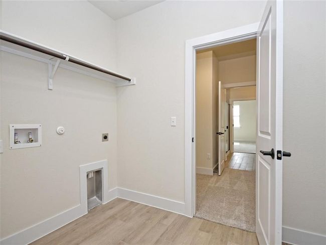 Washroom featuring washer hookup, hookup for an electric dryer, hookup for a gas dryer, and light wood-style floors | Image 16