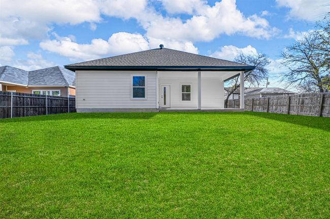 Rear view of property with a yard, a shingled roof, and a fenced backyard | Image 29
