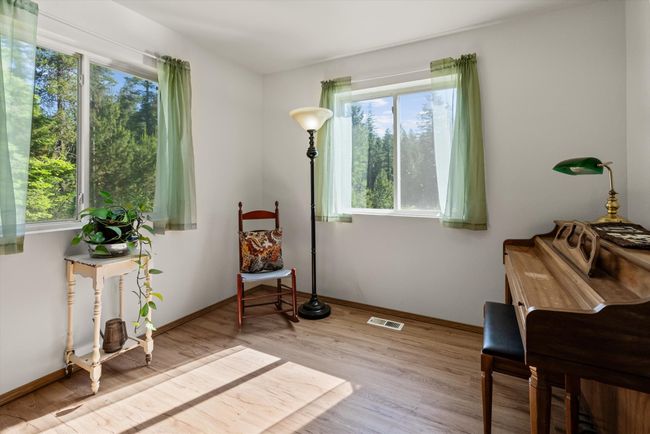 Living area featuring plenty of natural light, wood finished floors, and baseboards | Image 10