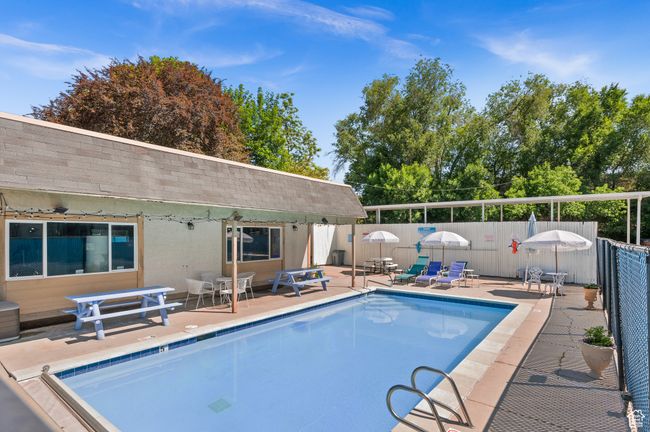 View of pool with a fenced backyard and a patio area | Image 6