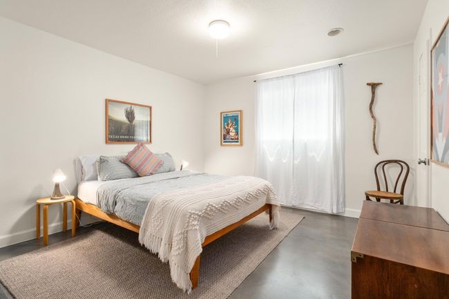 Bedroom with concrete flooring and baseboards | Image 12