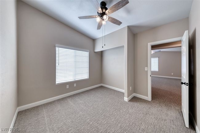 Unfurnished bedroom with carpet, multiple windows, vaulted ceiling, and ceiling fan | Image 27