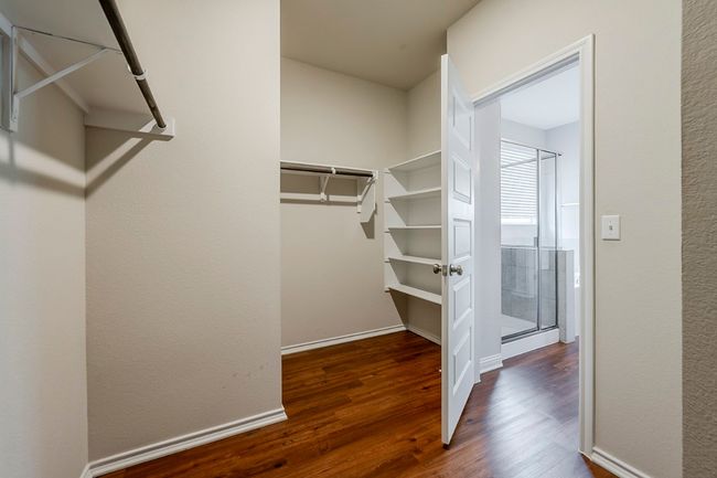 Walk in closet with wood finished floors | Image 17