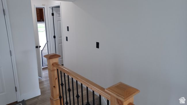 Hallway with an upstairs landing and wood finished floors | Image 4