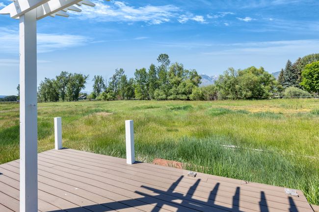 Wooden terrace with a view of countryside, a mountain view, and a dock | Image 49