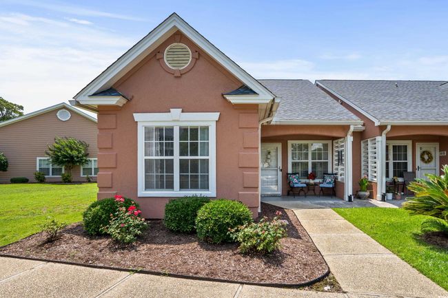 View of front of house featuring stucco siding, a front lawn, and roof with shingles | Image 35