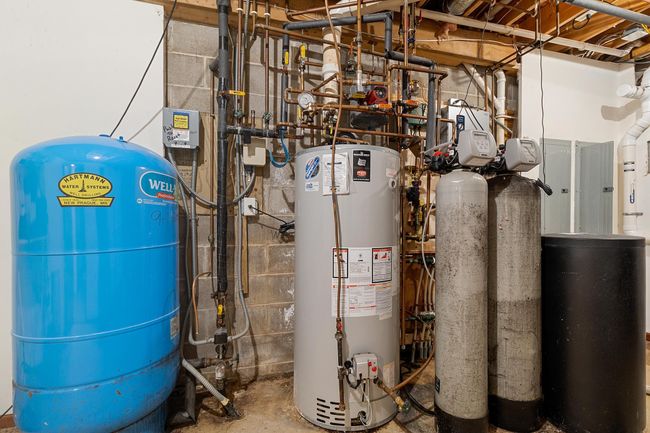 Main and lower lever level mechanical room. High-flow well delivers plenty of pressure and flow. Recent Lenox HVAC. Boiler for radiant heat that heats the heated attached garage and supplemental heat for lower level. | Image 85