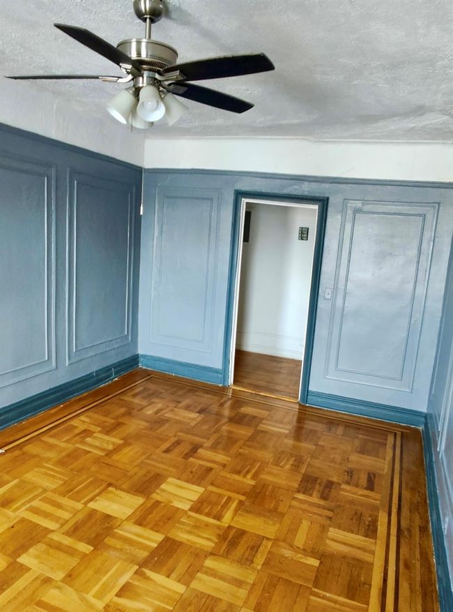 Unfurnished bedroom featuring a textured ceiling, ceiling fan, and a closet | Image 6