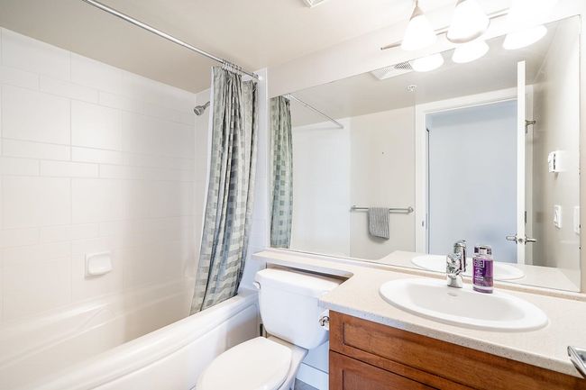 Full bathroom featuring toilet, shower / bathtub combination with curtain, visible vents, and vanity | Image 20