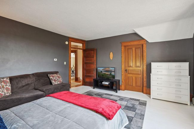 Here is another view of bedroom 2. The closet is a walk-in closet with stairs leading up to the attic. This room is freshly painted | Image 40