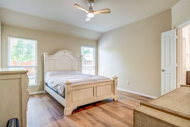 Bedroom featuring light wood-style flooring, a ceiling fan, and baseboards | Image 25