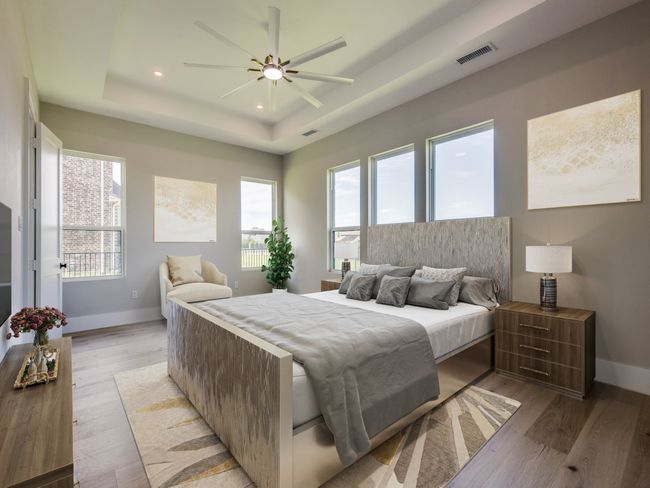 Virtual Staged Primary Bedroom featuring a tray ceiling, multiple windows, baseboard prewired for automatic window coverings | Image 32