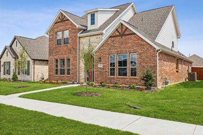 View of front of home with central air condition unit and a front yard | Image 2