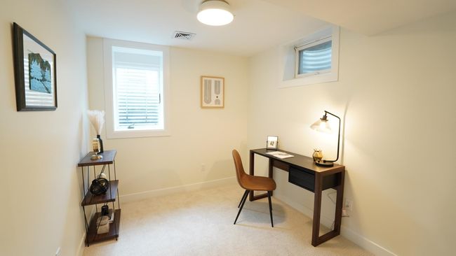 The newly added fourth bedroom in the lower level has been staged as an office, but could also act as a bedroom, a workout room, or even a crafting space. It features a brand new egress window, as well as new carpet, paint, lighting and closet. | Image 31