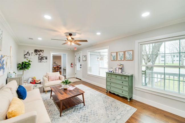 Living room featuring baseboards, wood finished floors, crown molding, and recessed lighting | Image 4