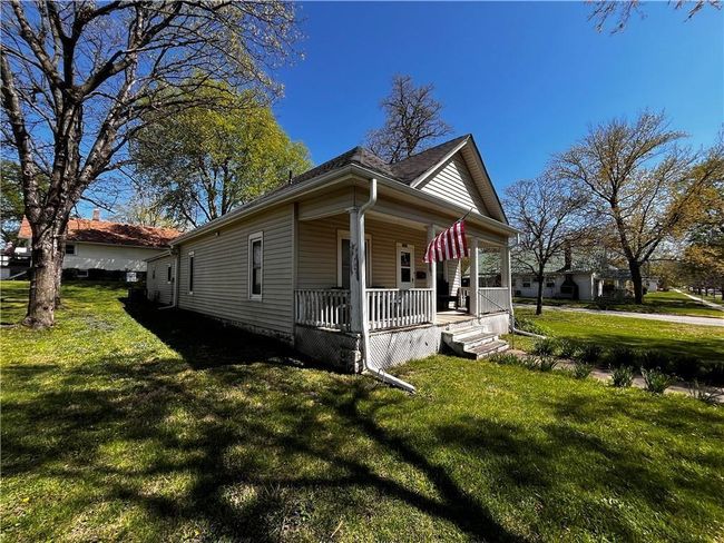 View of side of home with a porch and a yard | Image 4