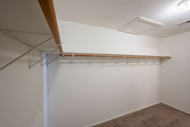Spacious closet featuring carpet flooring and attic access | Image 21