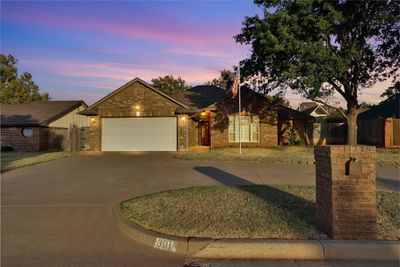 View of front facade with a yard and a garage | Image 1