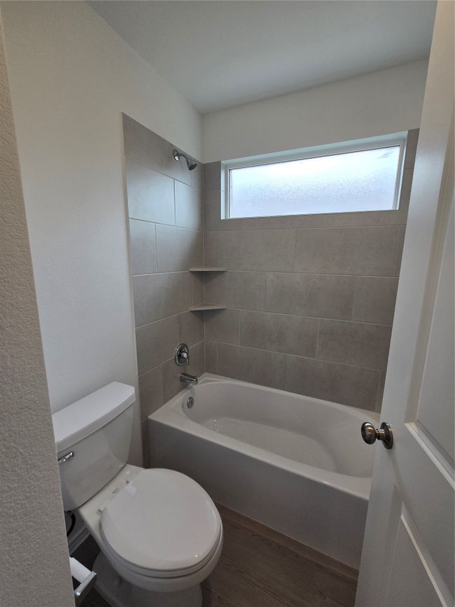 Bathroom with bathing tub / shower combination and wood finished floors | Image 23