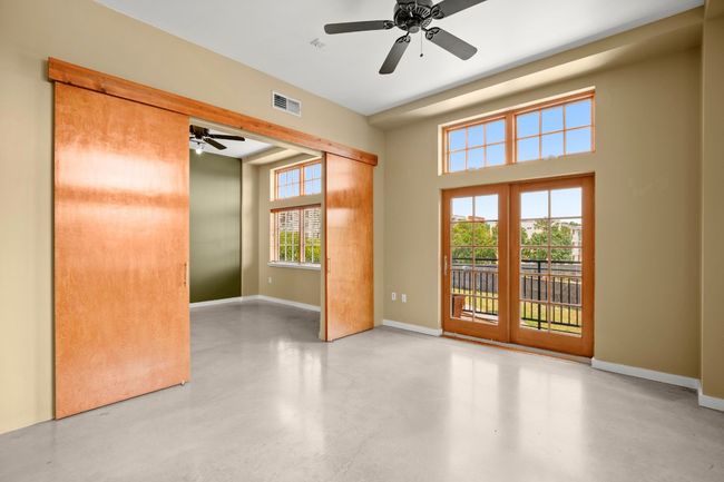 Living and french doors leading to outside covered patio. Installed privacy door for bedroom. | Image 5