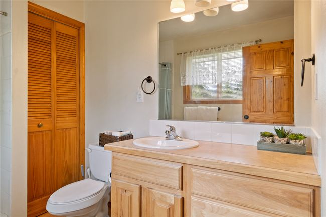 Bathroom featuring vanity, a closet, and a shower | Image 31