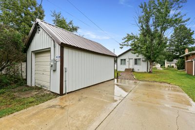 There is a single car garage and additional off street parking on the concrete parking pad. | Image 2