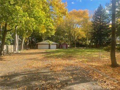 Lot surrounded by beautiful trees, 3-car, brick garage and shed | Image 2