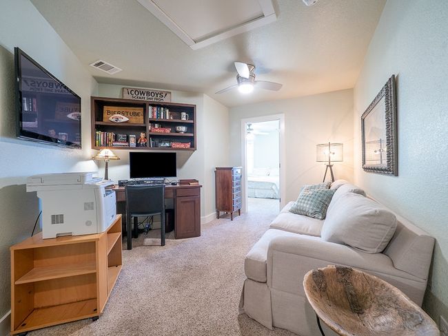 Office area featuring light carpet, a textured wall, and a ceiling fan | Image 22