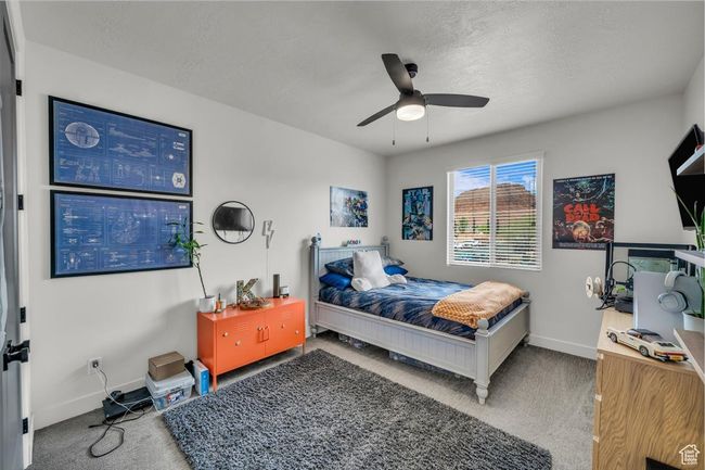 Bedroom with baseboards, carpet floors, a textured ceiling, and a ceiling fan | Image 16