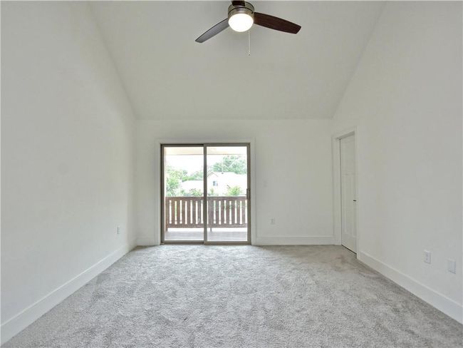 Carpeted spare room with a ceiling fan and high vaulted ceiling | Image 30