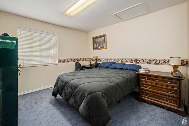Bedroom featuring baseboards, attic access, and carpet flooring | Image 34