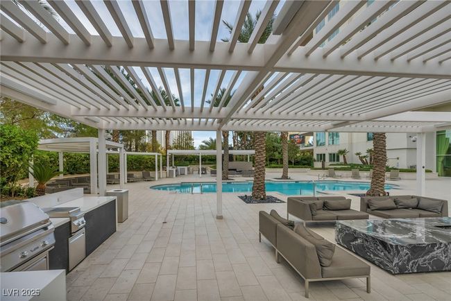 Community pool featuring area for grilling, exterior kitchen, a pergola, an outdoor hangout area, and a patio area | Image 68