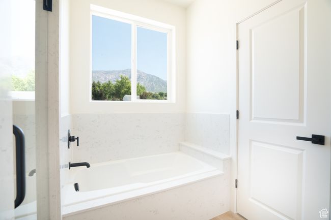 Full bathroom with a bath and a mountain view | Image 17