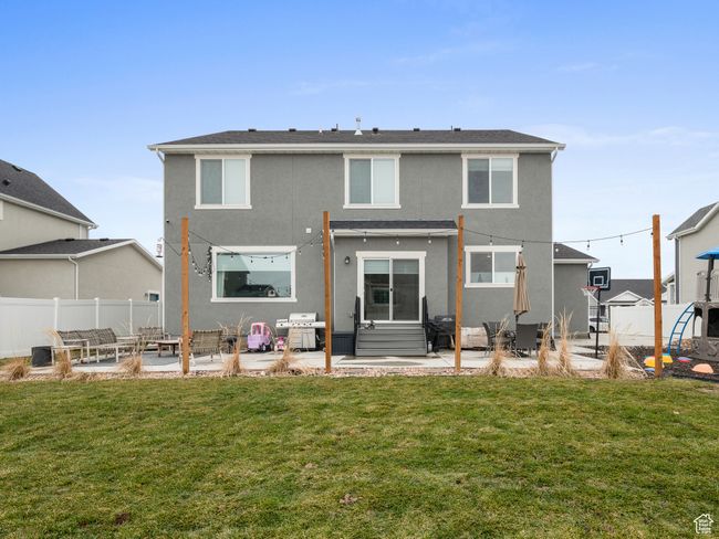 Rear view of property featuring an outdoor living space, stucco siding, and a patio area | Image 8